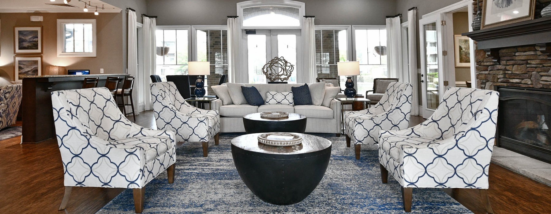a clubroom with a couch, tables and chairs