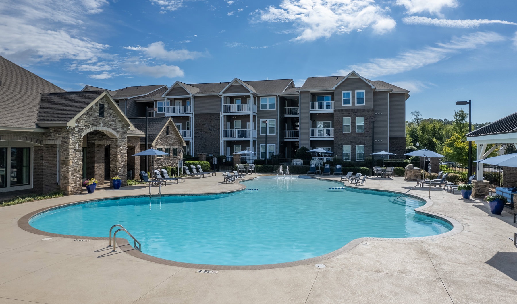 Resort-style swimming pool with lounge seating Resort-style swimming pool with lounge seating